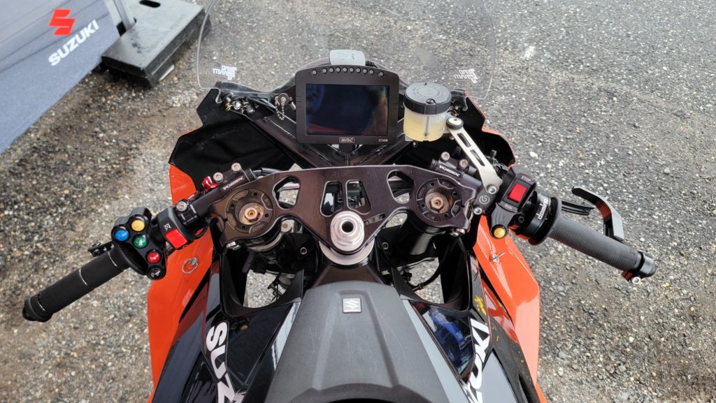 Cockpit of the Suzuki GSX8-R Twins Cup Race Bike. Adjustable Attack Triple Clamps, Ohlins Cartridges, Vortex Bars, MoTec Dash.